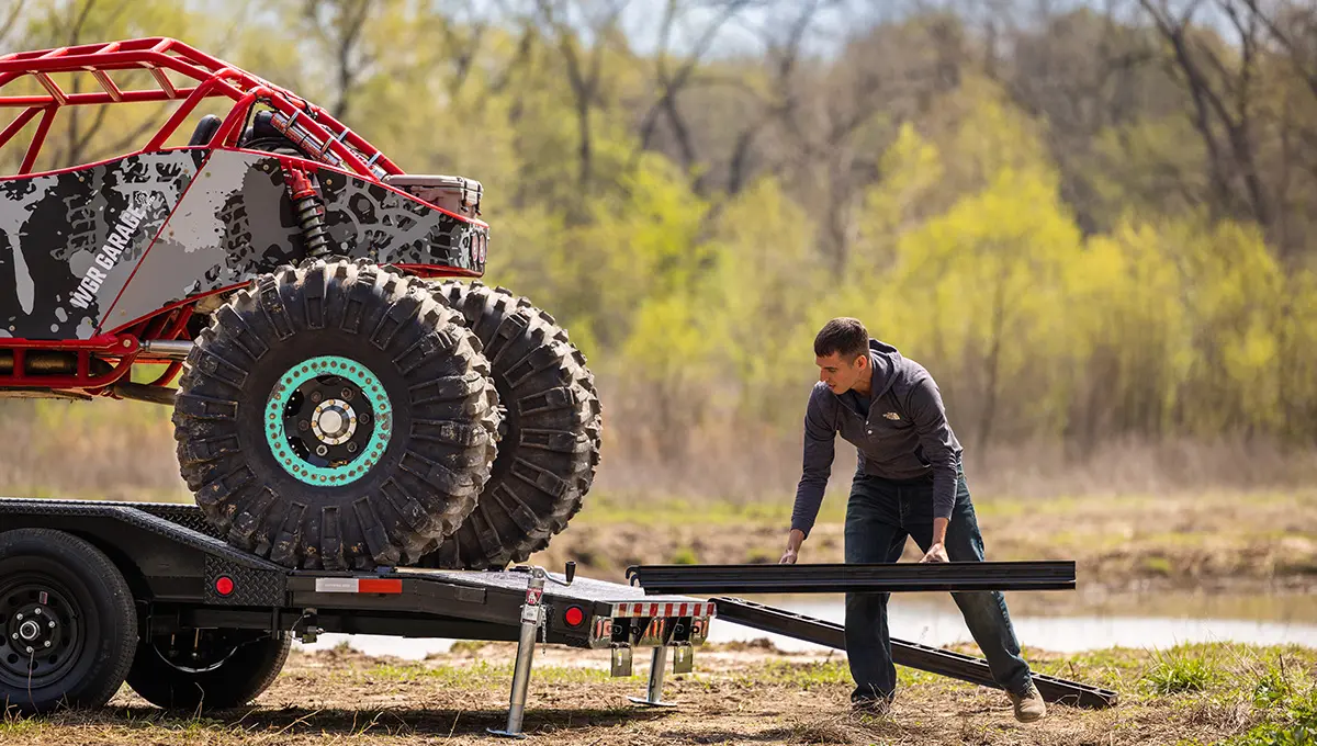 Man Putting 4 Wheeler on Channel Buggy Hauler