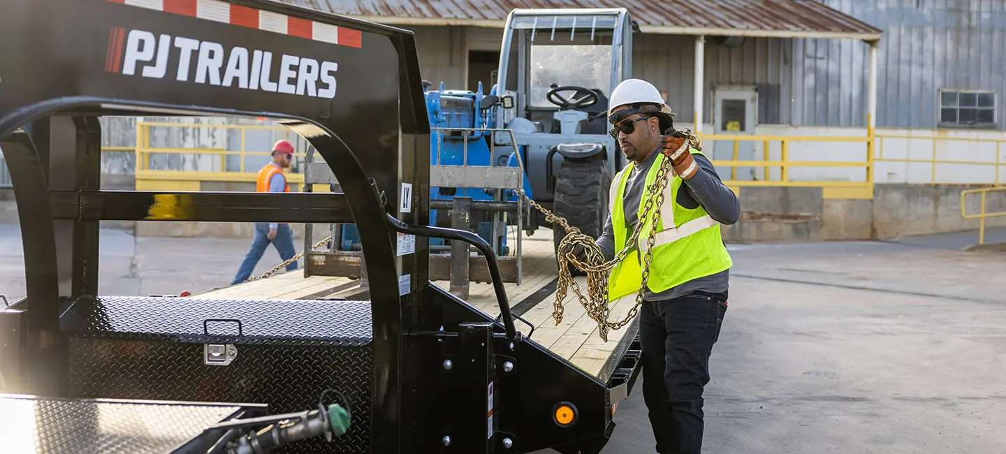 male worker chaining up trailer