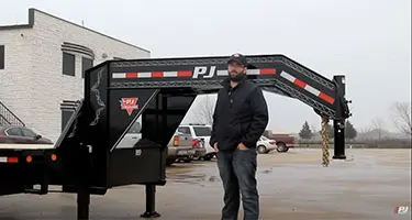 male standing in front of pj trailer in parking lot