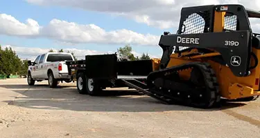 pickup truck hauling a trailer, trailer hauling a bulldozer