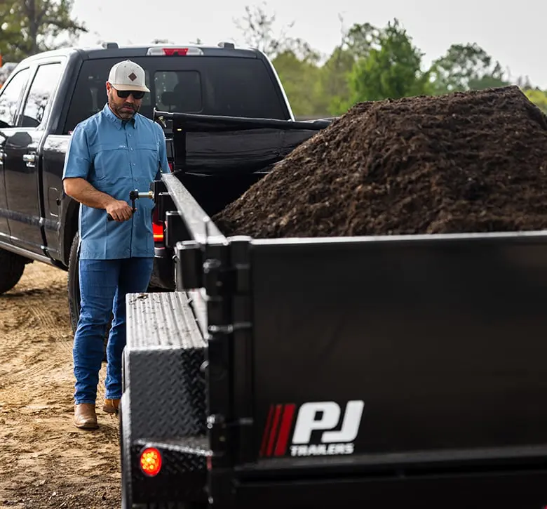 trailer hooked to a pickup truck hauling mulch