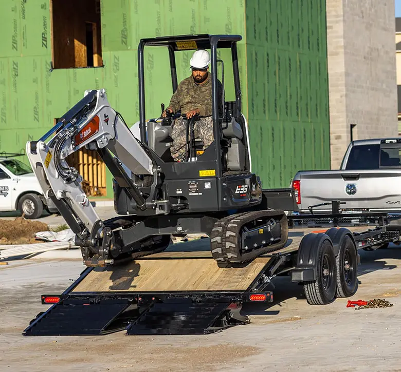 working unloading construction material off trailer