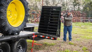Raising the loading ramps on the Low-Pro Flatdeck Trailer With 7K Singles