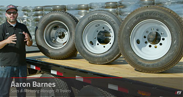 Sales & Marketing Manager Aaron Barnes explaining different types of trailer wheels