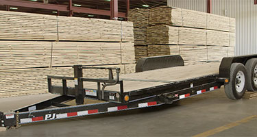 trailer in front of wood pallets