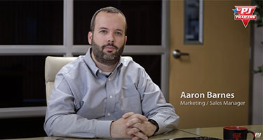 marketing and sales manager aaron barnes sitting at desk